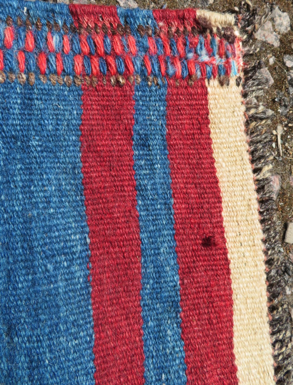 An antique flatweave Kurdish Tasheh wheat sack featuring vertical blue, red, cream, and brown stripes alongside a woven chevron motif. View XIII