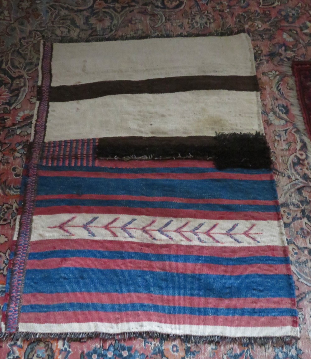 An antique flatweave Kurdish Tasheh wheat sack featuring vertical blue, red, cream, and brown stripes alongside a woven chevron motif. View XV