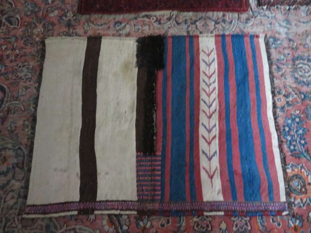 An antique flatweave Kurdish Tasheh wheat sack featuring vertical blue, red, cream, and brown stripes alongside a woven chevron motif. View XVI