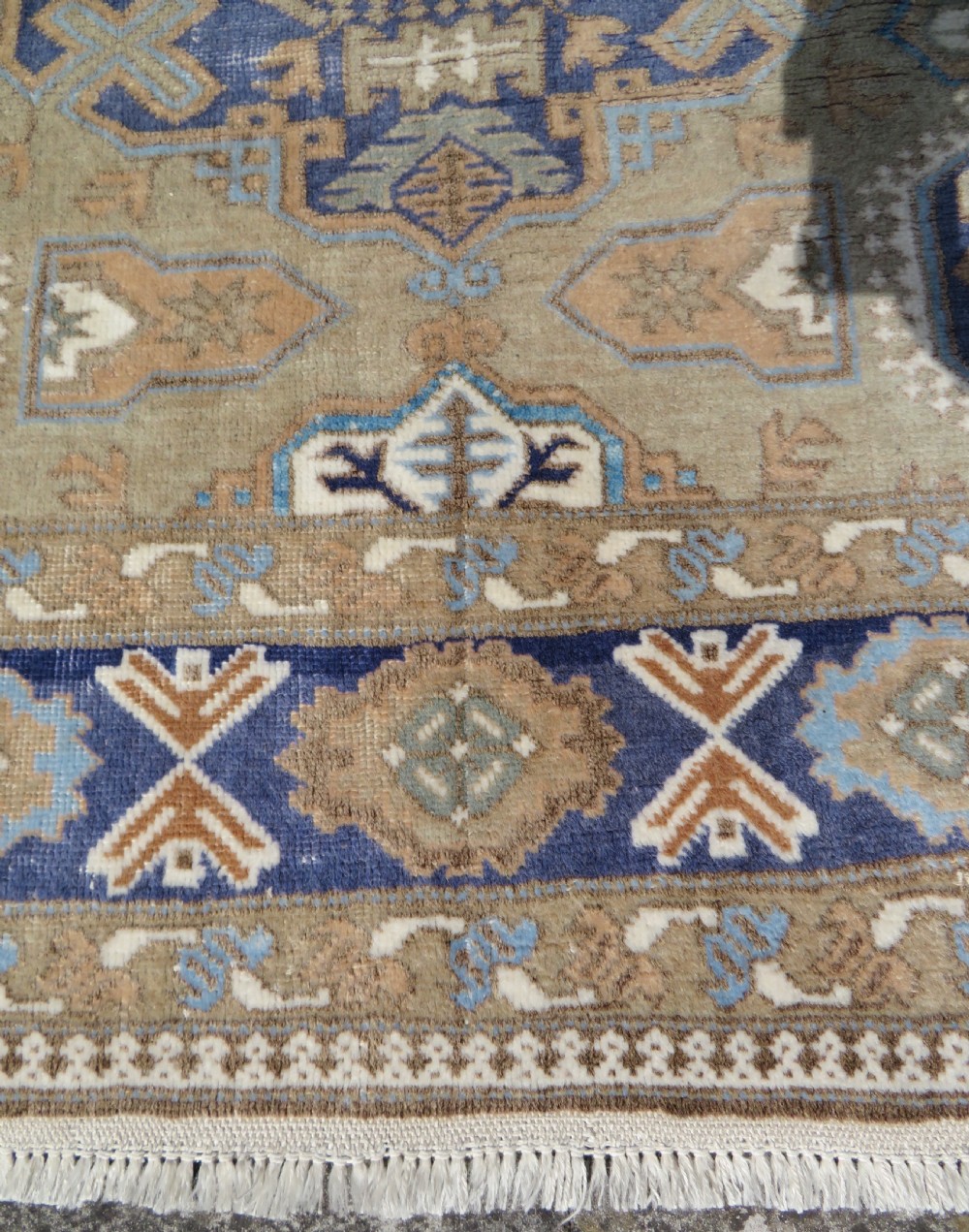 A hand-knotted North Persian Ardabil wool rug featuring three central geometric medallions in blue, cream, and beige on a neutral field with patterned borders. View XII