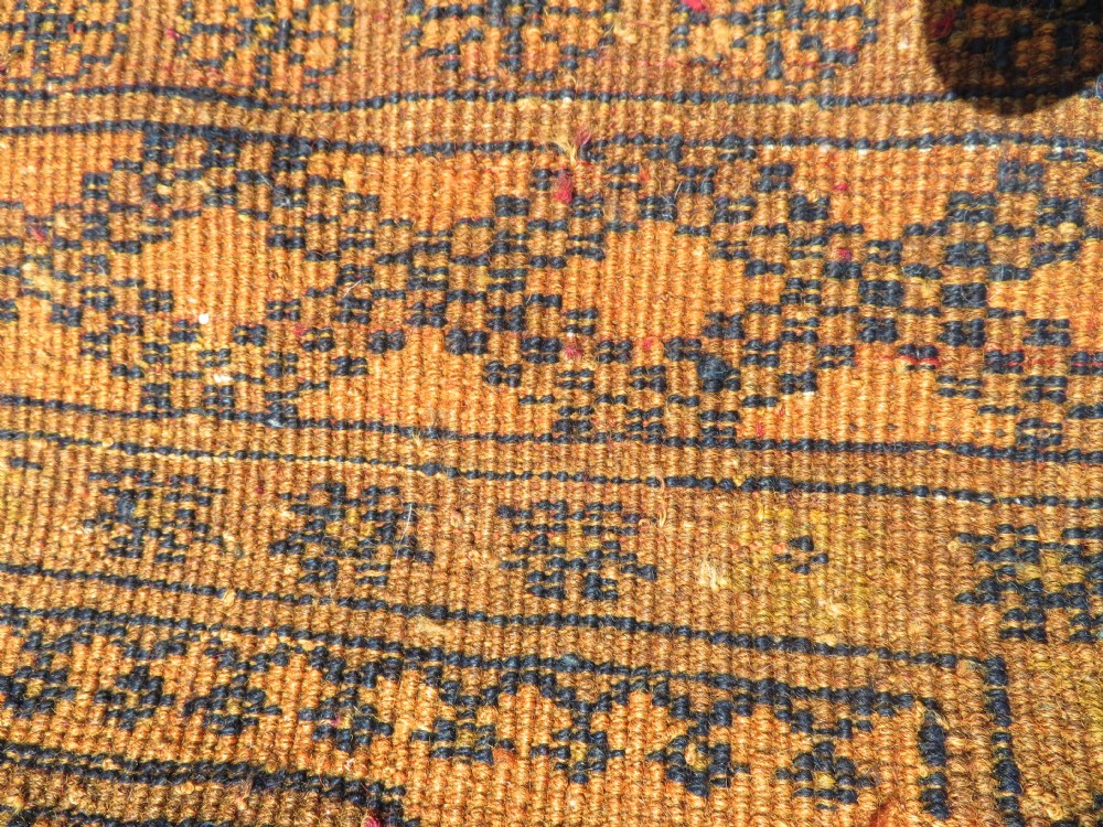 A rectangular hand-knotted Afghan wool rug with dark blue octagonal gul motifs set against a rich gold field with geometric borders. View XIII