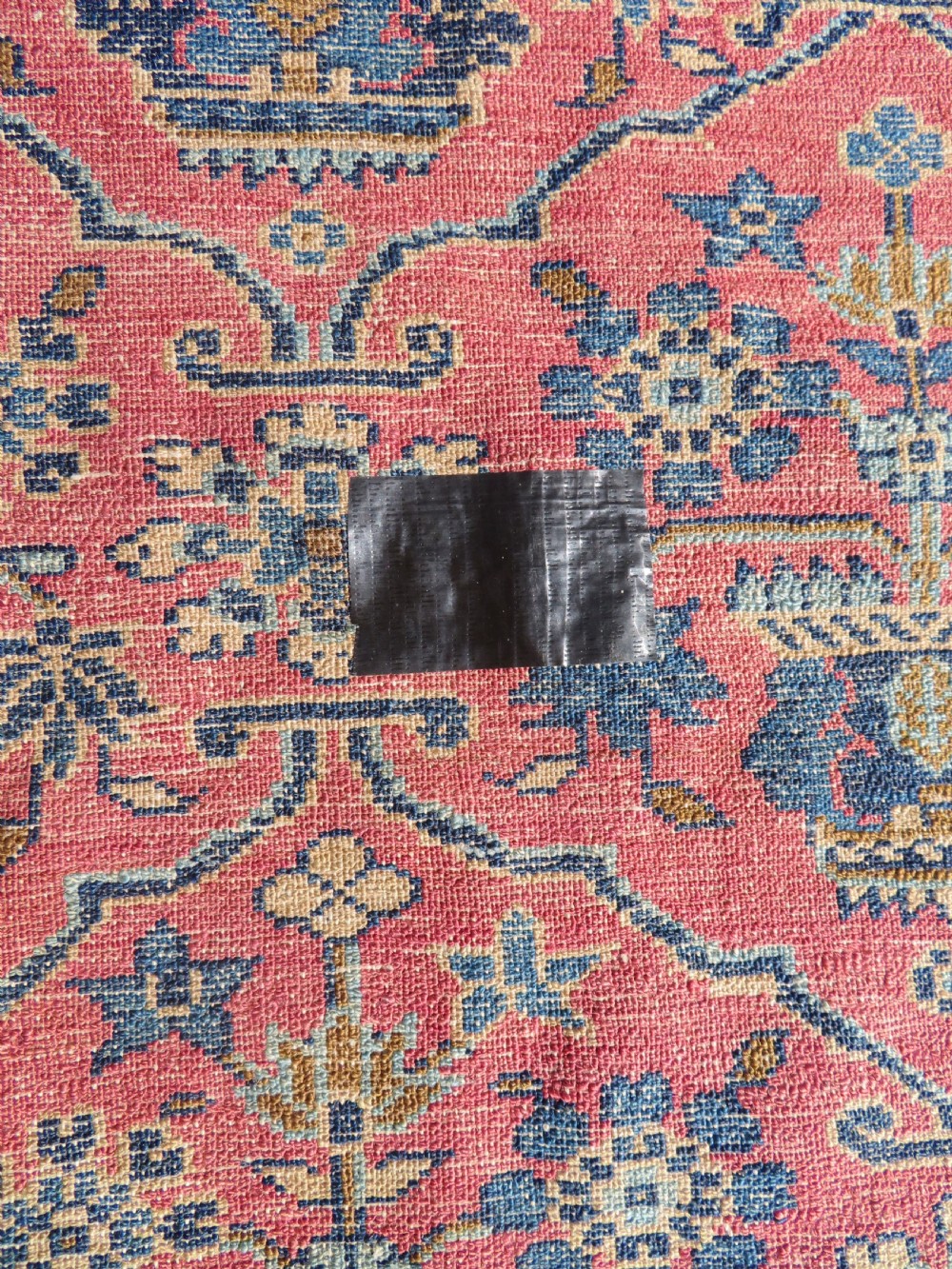 An antique West Persian Sarouk hand-knotted wool rug featuring a rose pink field adorned with floral vase motifs and a navy blue floral border. View XIV