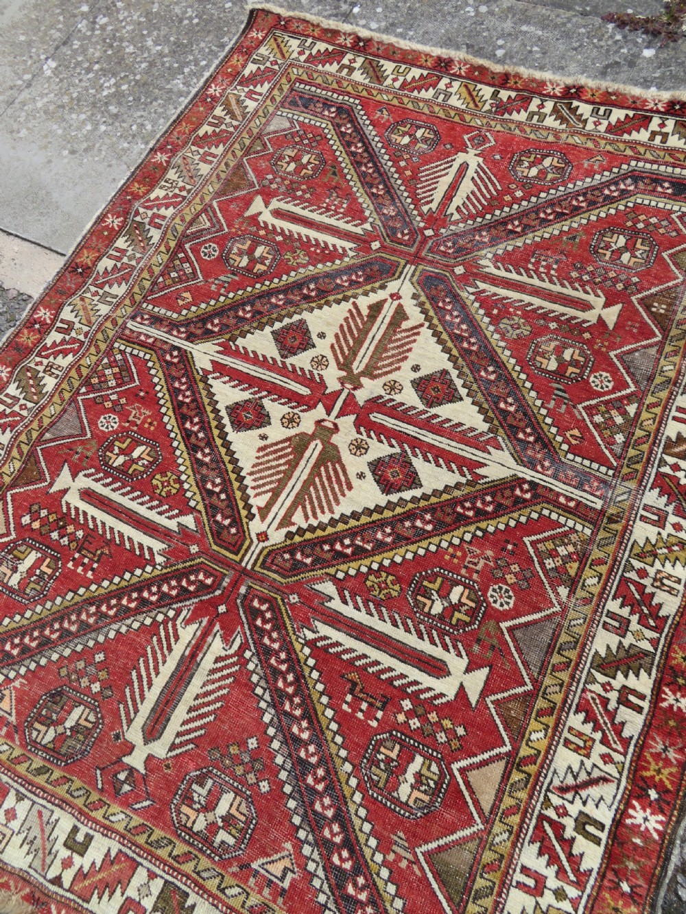 An antique hand-knotted Shirvan wool rug featuring a central diamond medallion, geometric motifs, and detailed borders in shades of red, cream, and brown. View XIV