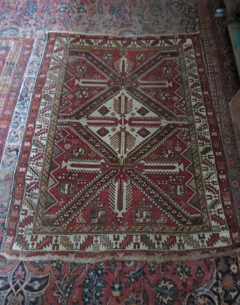 An antique hand-knotted Shirvan wool rug featuring a central diamond medallion, geometric motifs, and detailed borders in shades of red, cream, and brown. View XX