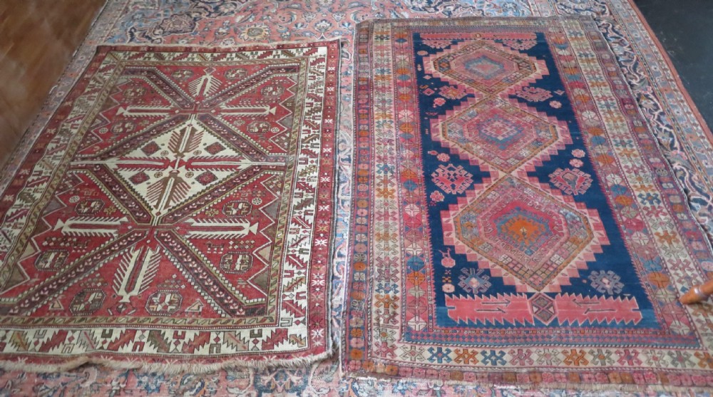 An antique hand-knotted Shirvan wool rug featuring a central diamond medallion, geometric motifs, and detailed borders in shades of red, cream, and brown. View XXII