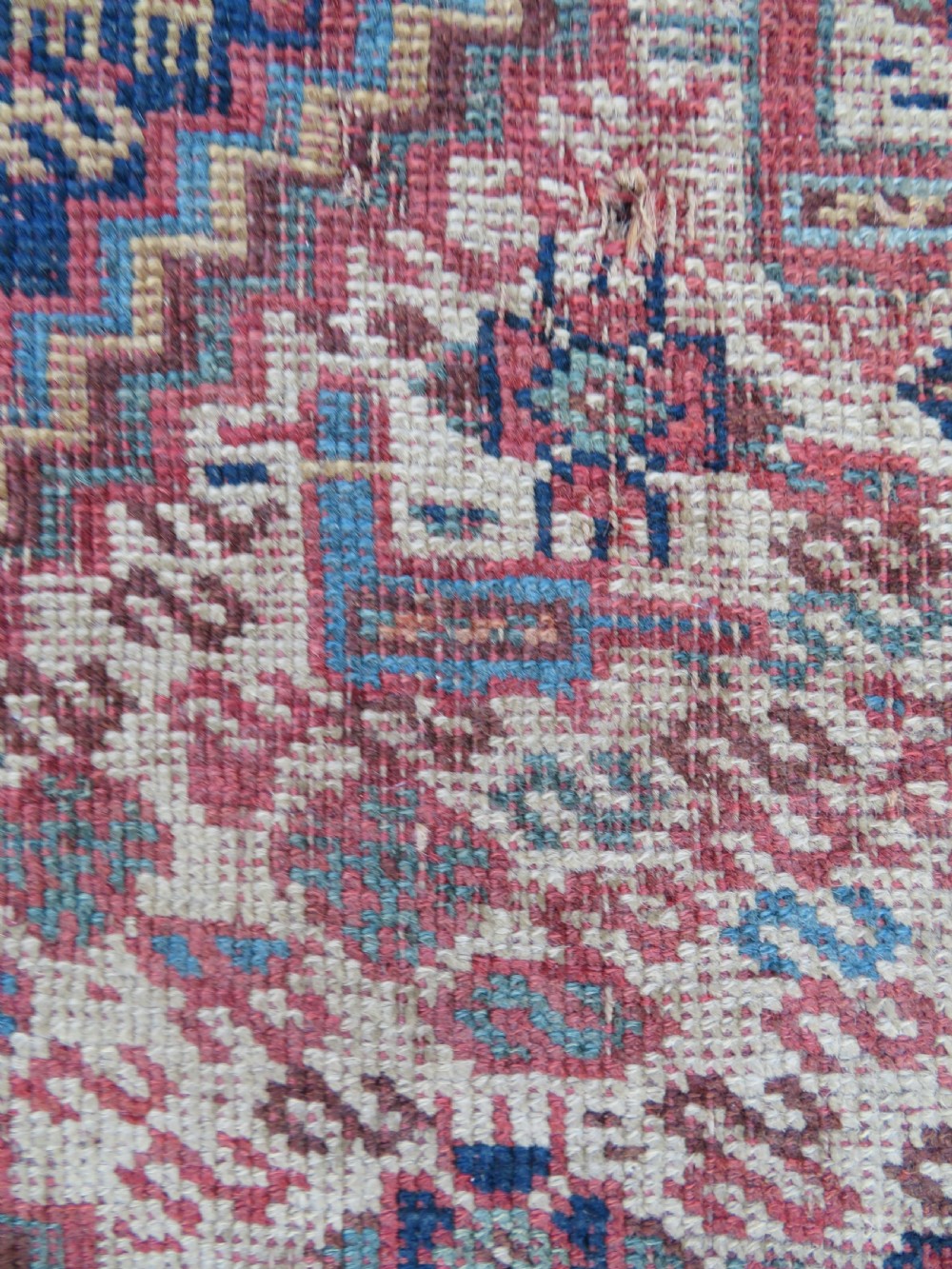 An antique Khamseh nomadic wool rug featuring complex geometric medallions, bird motifs, and multi-layered borders in terracotta, navy blue, and cream. View VI