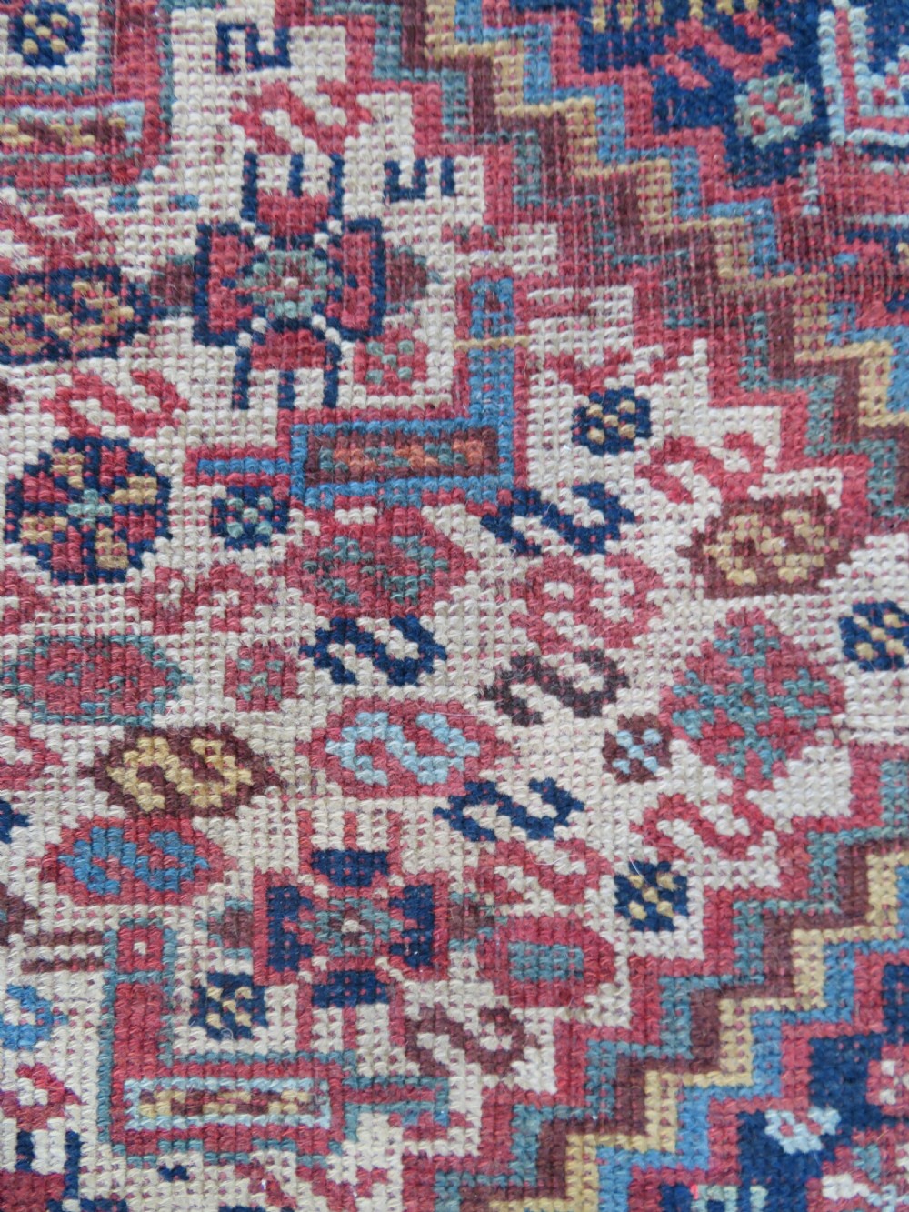 An antique Khamseh nomadic wool rug featuring complex geometric medallions, bird motifs, and multi-layered borders in terracotta, navy blue, and cream. View VII
