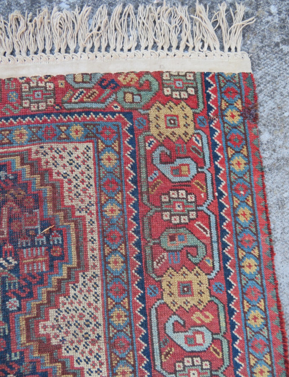 An antique Khamseh nomadic wool rug featuring complex geometric medallions, bird motifs, and multi-layered borders in terracotta, navy blue, and cream. View XIV