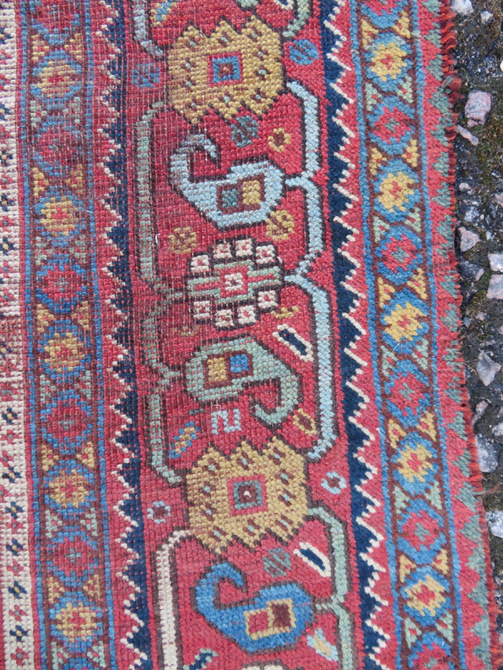 An antique Khamseh nomadic wool rug featuring complex geometric medallions, bird motifs, and multi-layered borders in terracotta, navy blue, and cream. View XV