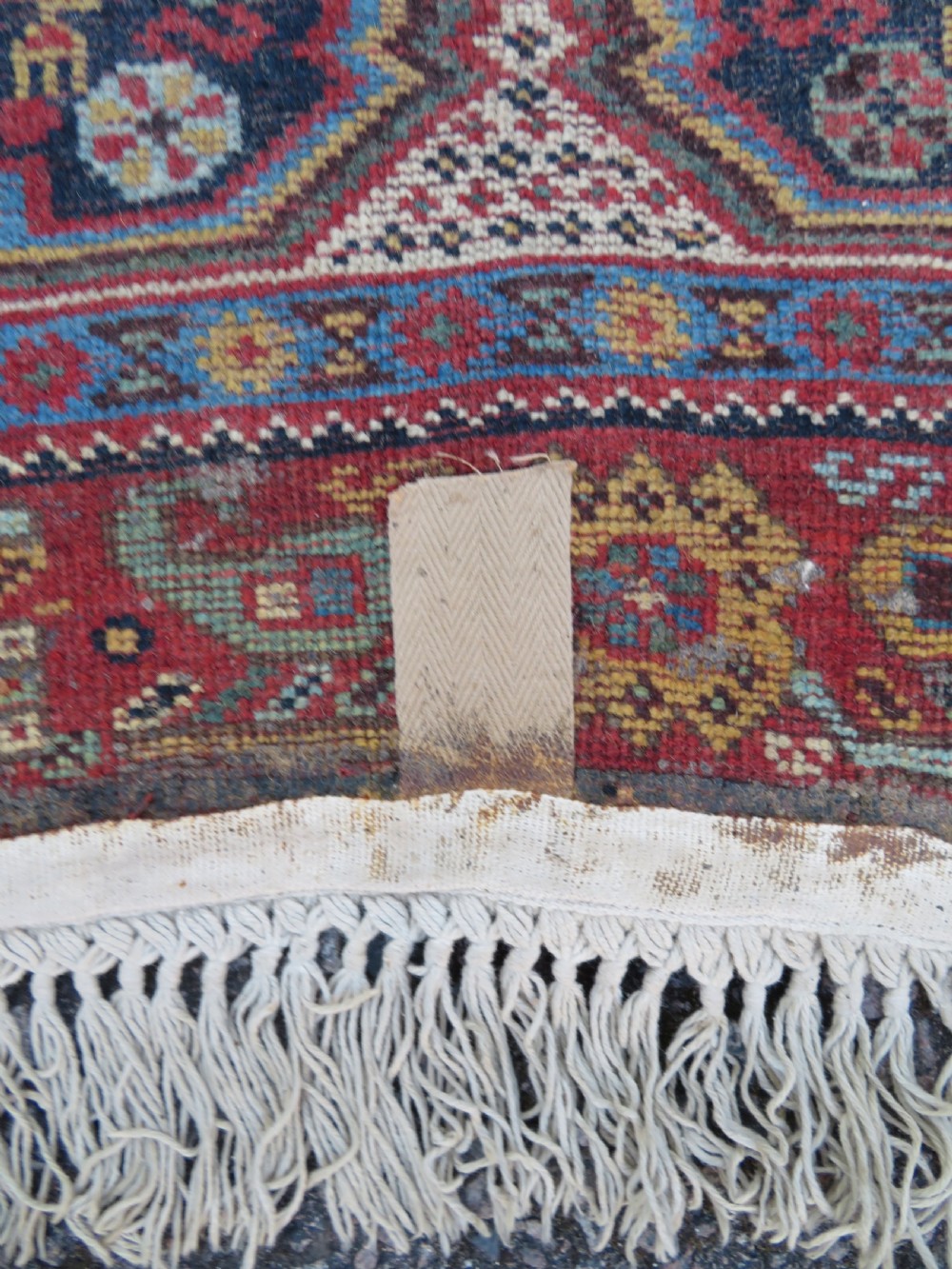 An antique Khamseh nomadic wool rug featuring complex geometric medallions, bird motifs, and multi-layered borders in terracotta, navy blue, and cream. View XXI