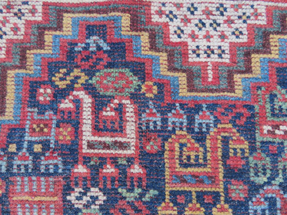 An antique Khamseh nomadic wool rug featuring complex geometric medallions, bird motifs, and multi-layered borders in terracotta, navy blue, and cream. View XXIII