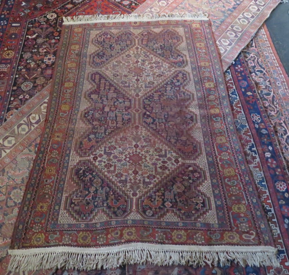 An antique Khamseh nomadic wool rug featuring complex geometric medallions, bird motifs, and multi-layered borders in terracotta, navy blue, and cream. View XXIV