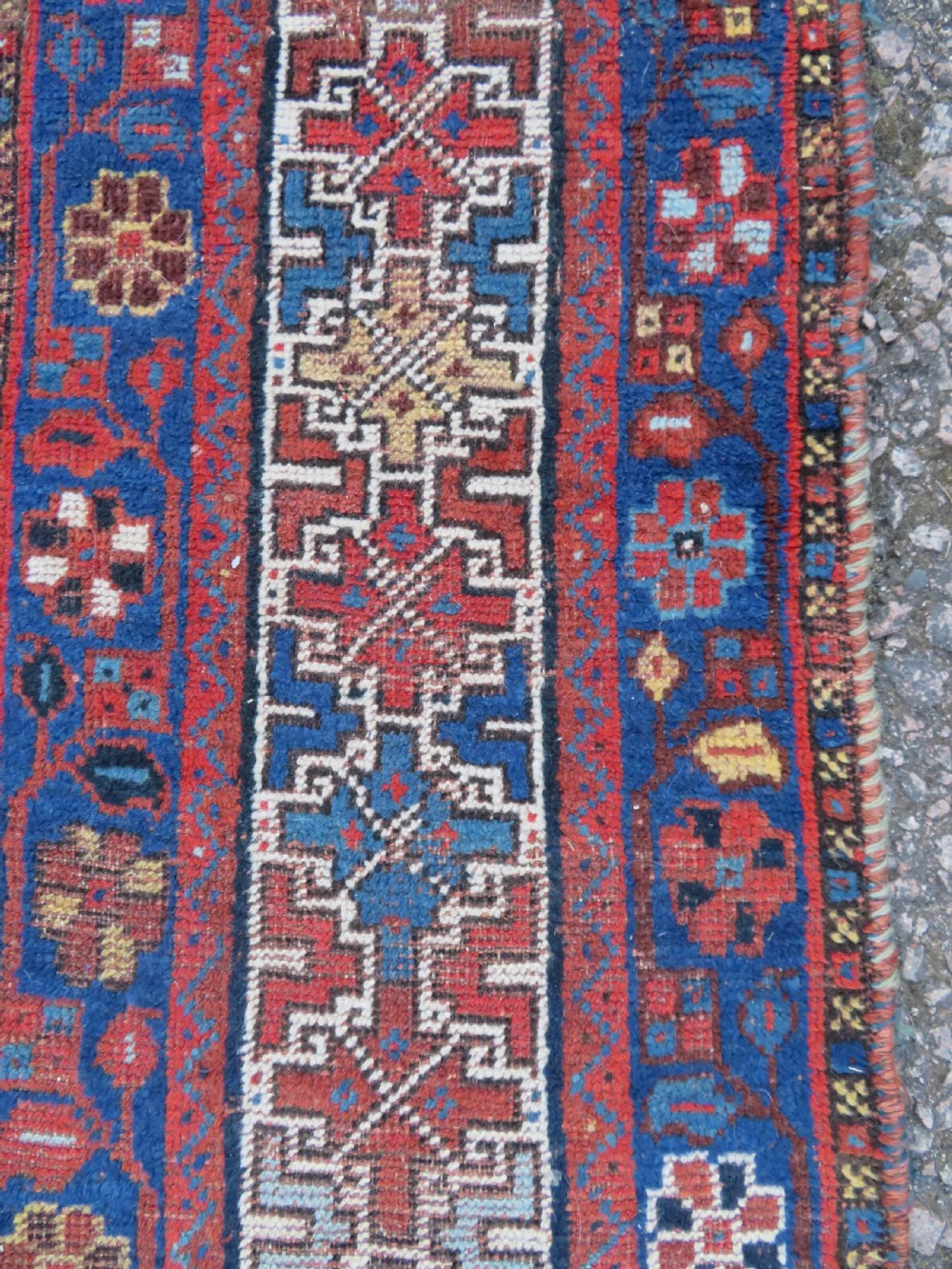 An antique Persian Khamseh wool carpet featuring a dark navy blue field with three stacked diamond medallions and geometric borders in terracotta red and ivory. View XXIII