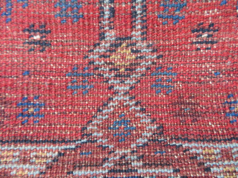An antique Persian Khamseh wool carpet featuring a dark navy blue field with three stacked diamond medallions and geometric borders in terracotta red and ivory. View XXVIII