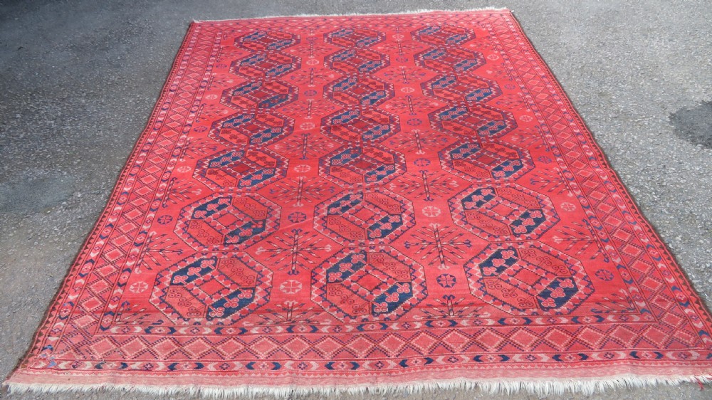 A large hand-knotted red wool Ersari carpet featuring repeating octagonal gul motifs and geometric border bands. View II