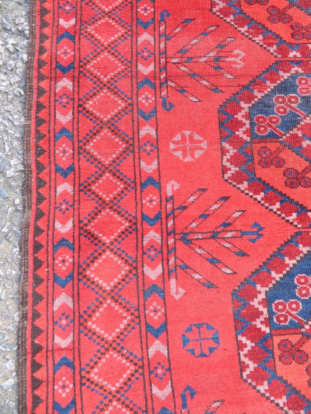 A large hand-knotted red wool Ersari carpet featuring repeating octagonal gul motifs and geometric border bands. View XIV