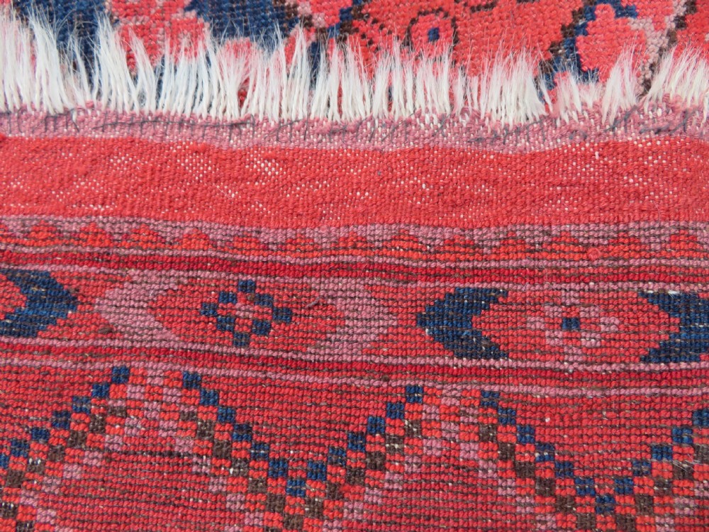 A large hand-knotted red wool Ersari carpet featuring repeating octagonal gul motifs and geometric border bands. View XXIII
