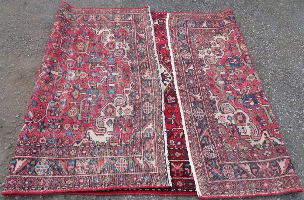 A long hand-knotted Persian Hamadan Kelleh carpet featuring a central cream medallion surrounded by geometric and floral motifs on a red field with multi-tiered borders. View XIV