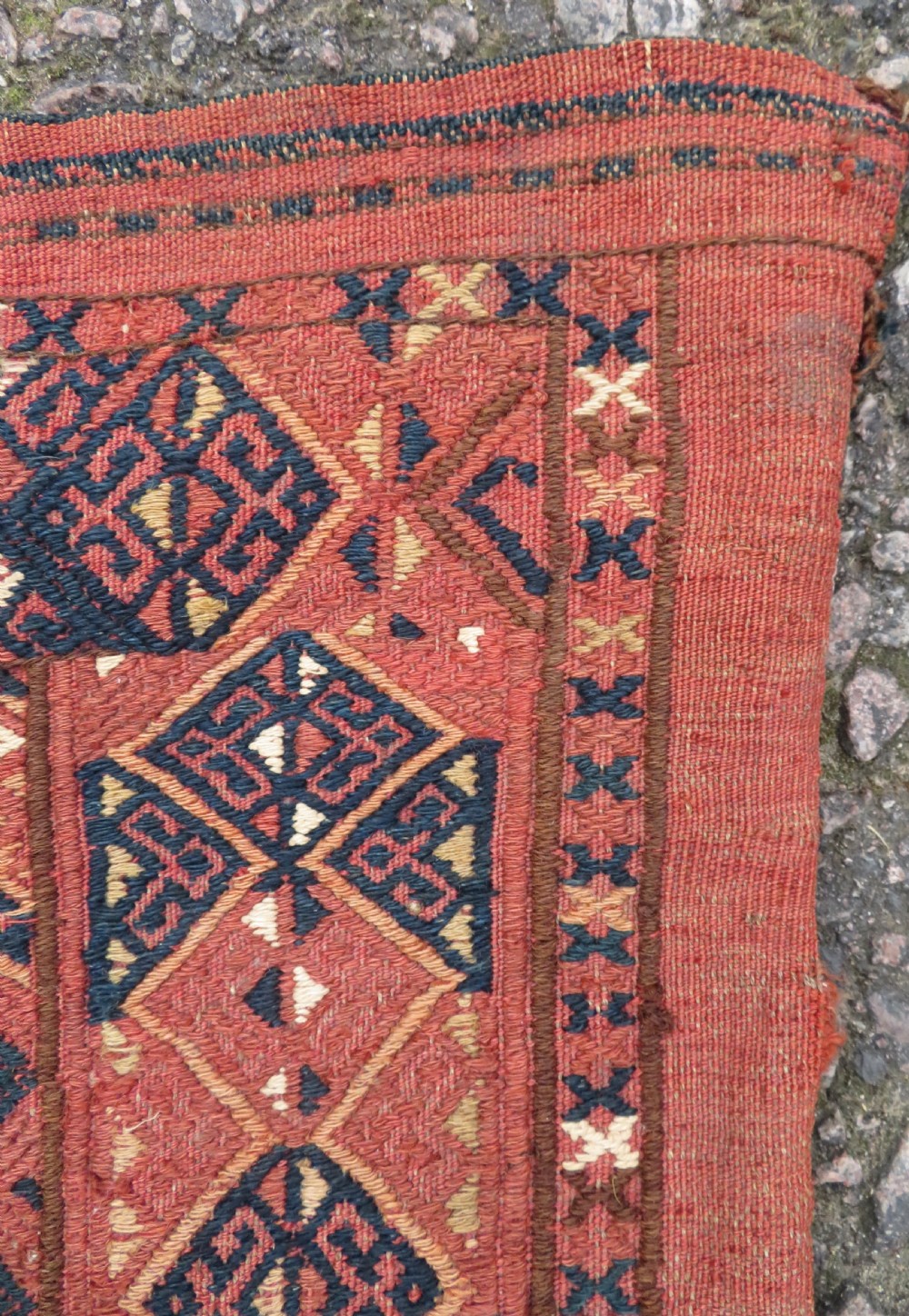 An Ersari Turkmen flatweave wool torba featuring geometric motifs in terracotta red, navy, and ivory, complete with a long fringed lower border. View IV