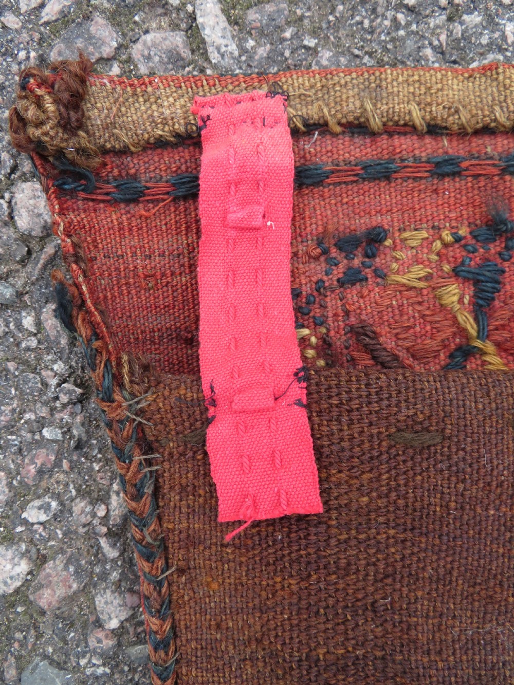 An Ersari Turkmen flatweave wool torba featuring geometric motifs in terracotta red, navy, and ivory, complete with a long fringed lower border. View XIV