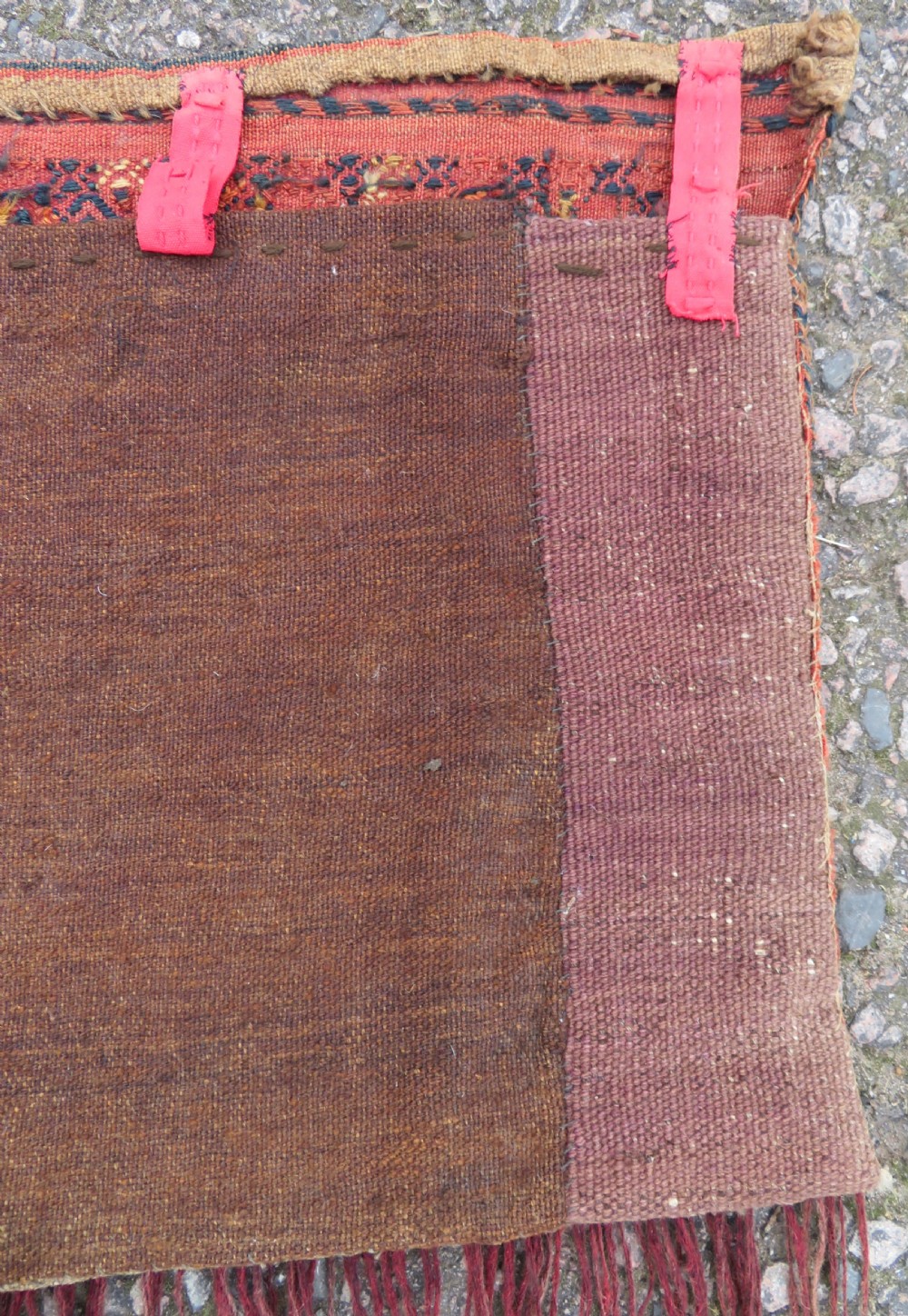 An Ersari Turkmen flatweave wool torba featuring geometric motifs in terracotta red, navy, and ivory, complete with a long fringed lower border. View XV