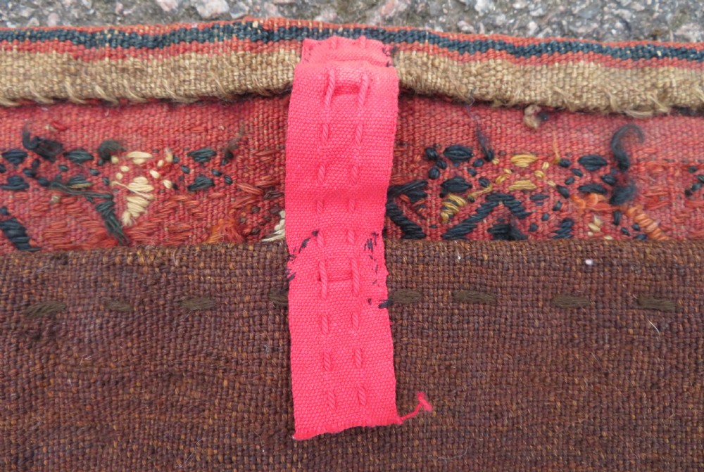 An Ersari Turkmen flatweave wool torba featuring geometric motifs in terracotta red, navy, and ivory, complete with a long fringed lower border. View XVI
