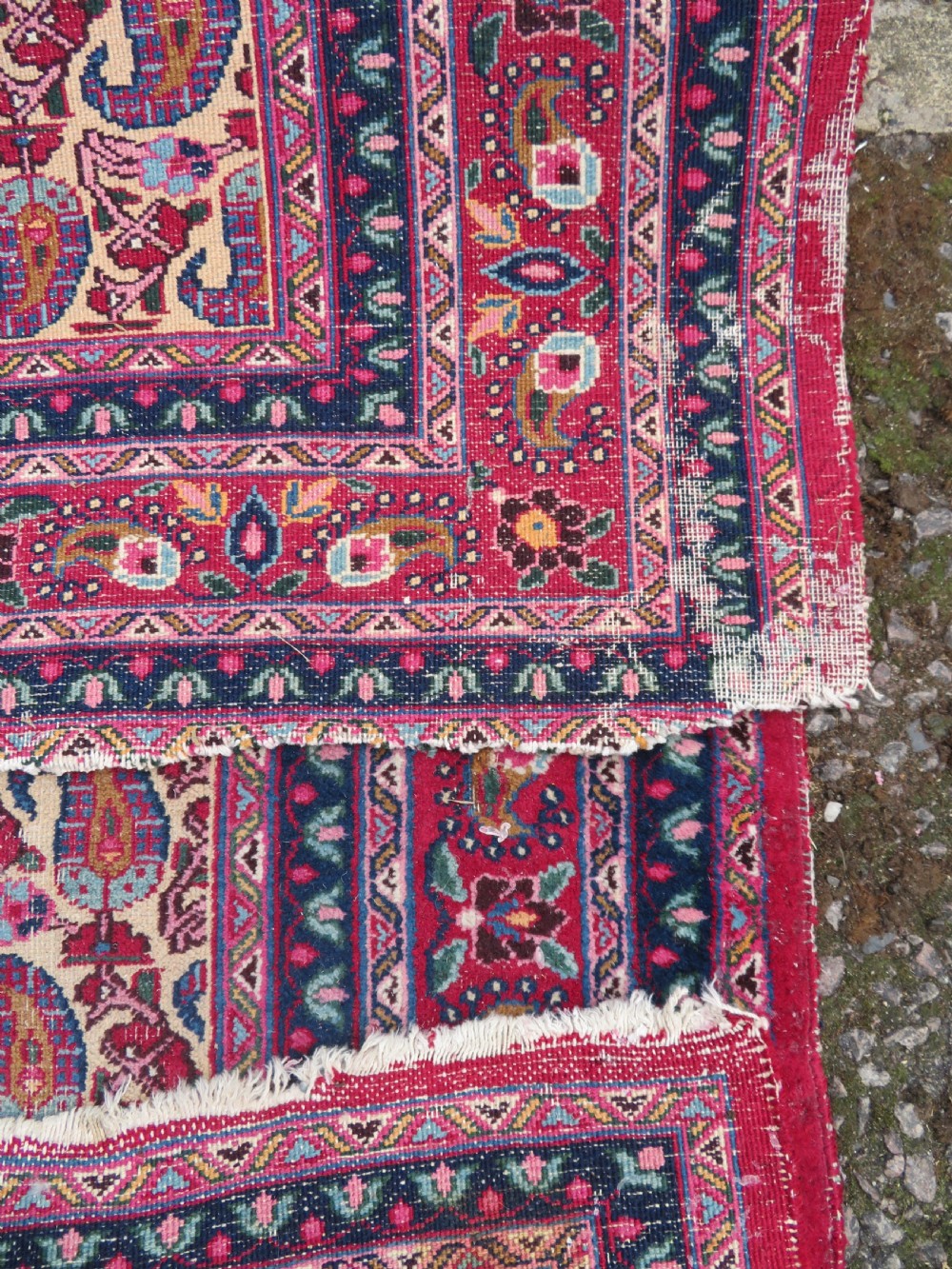 An antique Persian Meshed Doroksh wool rug featuring a repeating all-over boteh pattern on a cream field within multi-banded crimson and navy borders. View XV