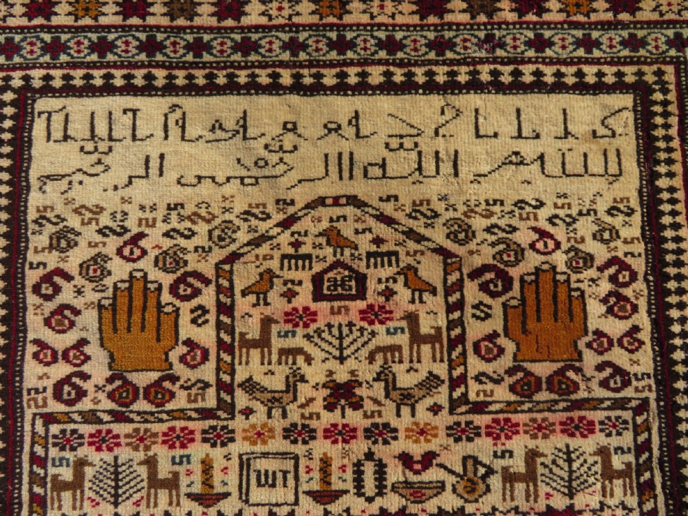 Hand-knotted wool Baluch prayer rug with a cream field featuring stylized camels, birds, hand symbols, and a mihrab top border. View II