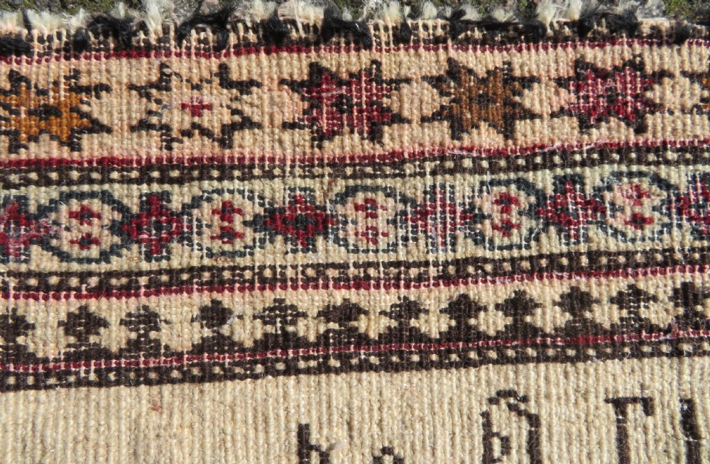 Hand-knotted wool Baluch prayer rug with a cream field featuring stylized camels, birds, hand symbols, and a mihrab top border. View XI