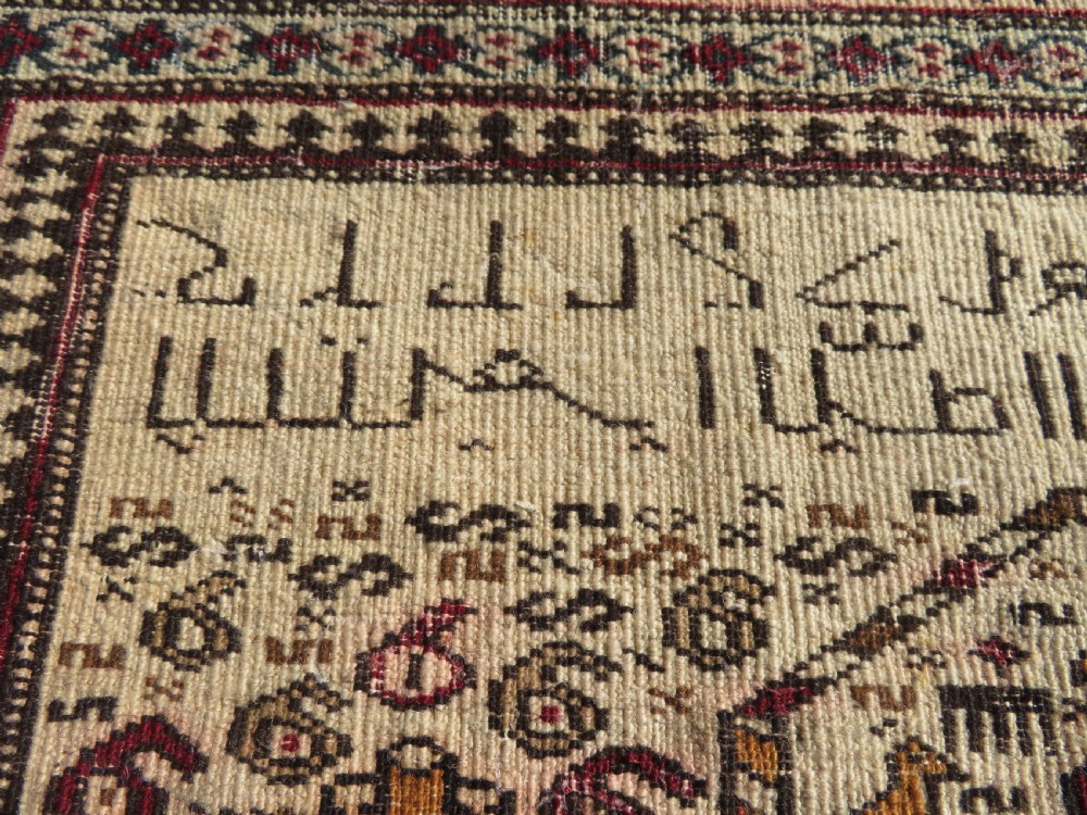 Hand-knotted wool Baluch prayer rug with a cream field featuring stylized camels, birds, hand symbols, and a mihrab top border. View XIII