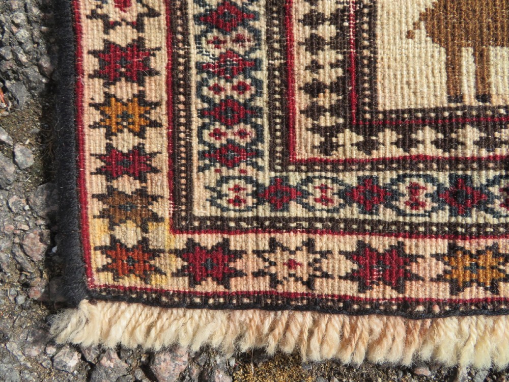 Hand-knotted wool Baluch prayer rug with a cream field featuring stylized camels, birds, hand symbols, and a mihrab top border. View XIV