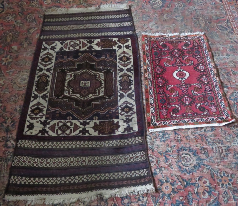 A pair of hand-woven tribal wool rugs featuring geometric medallions in tones of red, blue, brown, and cream with fringed edges. View XIII