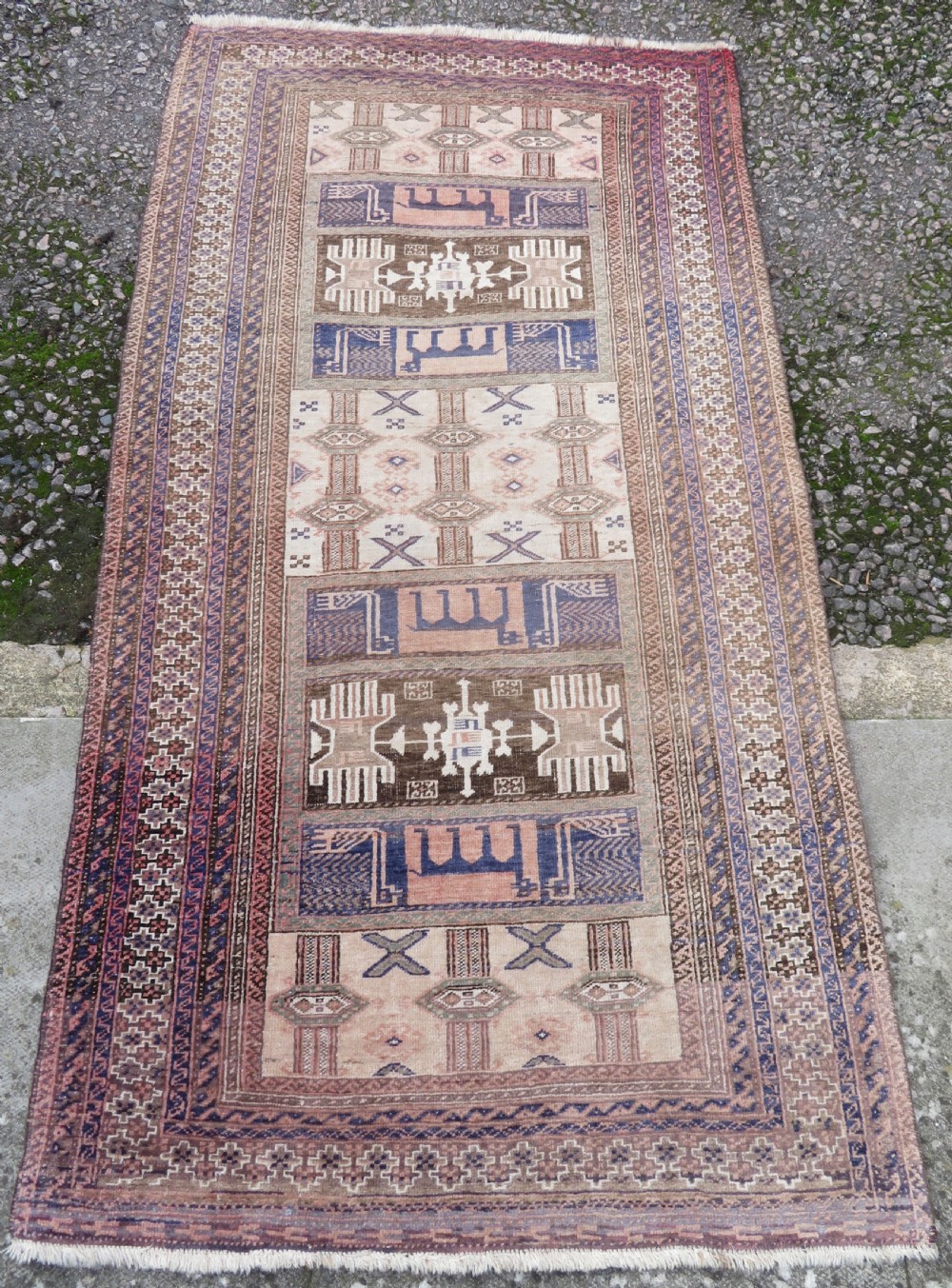 A hand-knotted Afghan wool rug featuring panelled sections with stylized animal motifs and geometric borders in terracotta, beige, brown, and navy blue hues. View II