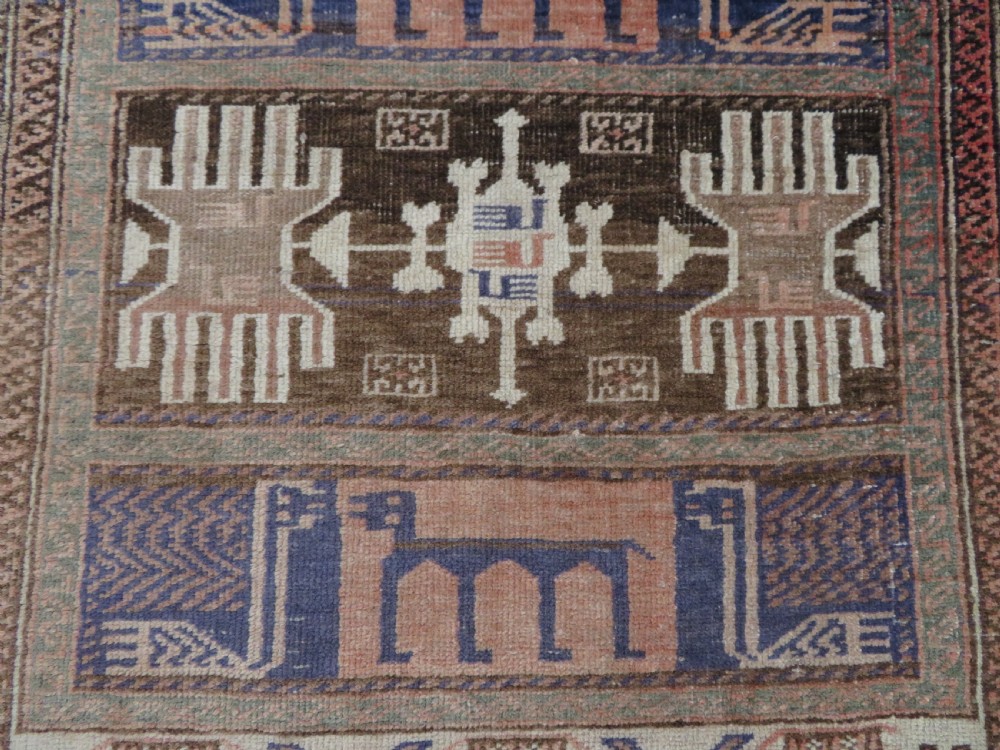 A hand-knotted Afghan wool rug featuring panelled sections with stylized animal motifs and geometric borders in terracotta, beige, brown, and navy blue hues. View VIII