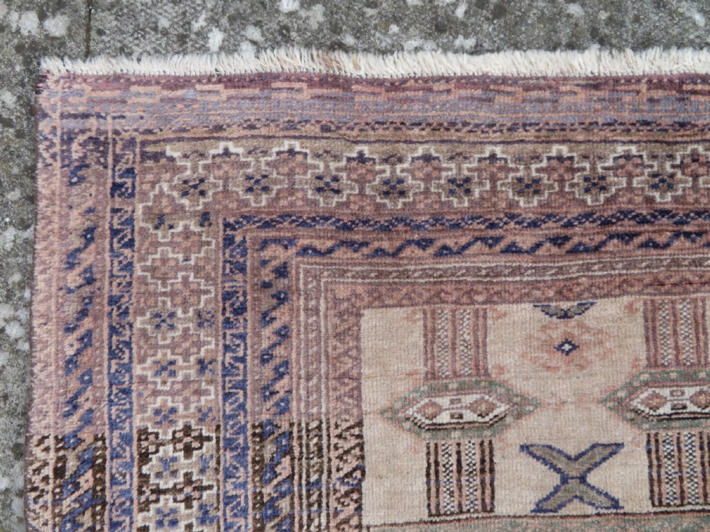 A hand-knotted Afghan wool rug featuring panelled sections with stylized animal motifs and geometric borders in terracotta, beige, brown, and navy blue hues. View IX