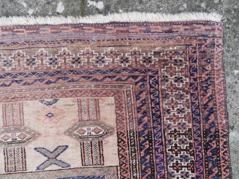 A hand-knotted Afghan wool rug featuring panelled sections with stylized animal motifs and geometric borders in terracotta, beige, brown, and navy blue hues. View X