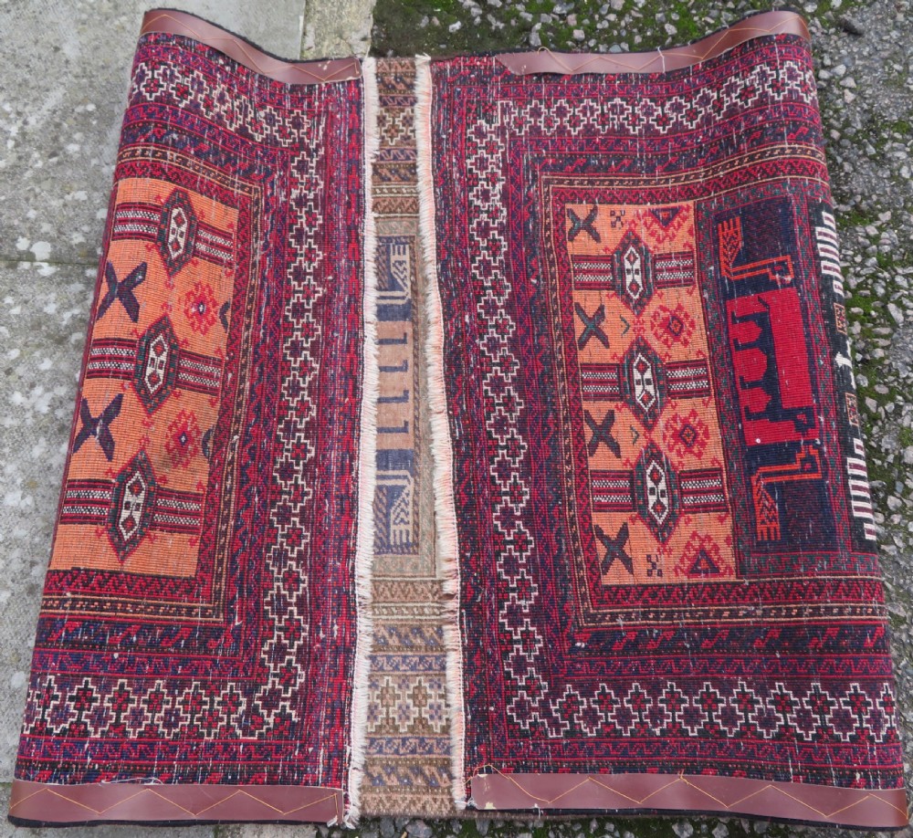 A hand-knotted Afghan wool rug featuring panelled sections with stylized animal motifs and geometric borders in terracotta, beige, brown, and navy blue hues. View XIV