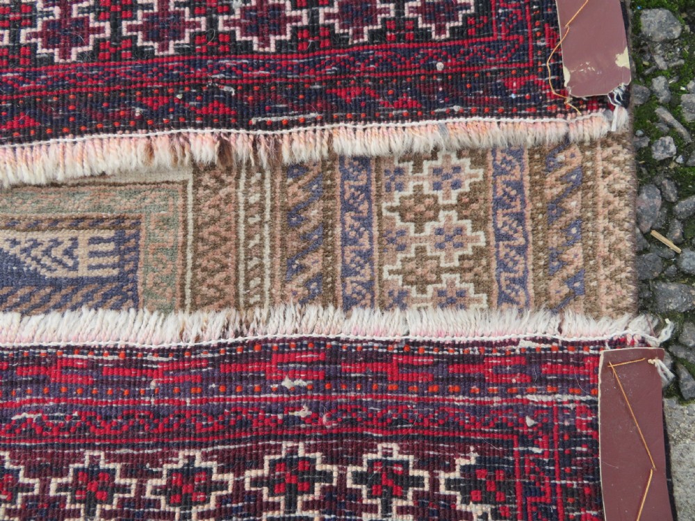 A hand-knotted Afghan wool rug featuring panelled sections with stylized animal motifs and geometric borders in terracotta, beige, brown, and navy blue hues. View XV