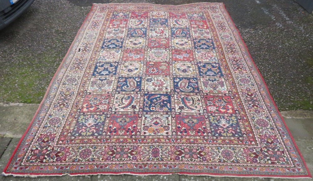 A large hand-knotted Persian Qum carpet with a square compartment panel design featuring floral and boteh motifs in red, blue, and cream enclosed by multi-band borders. View II