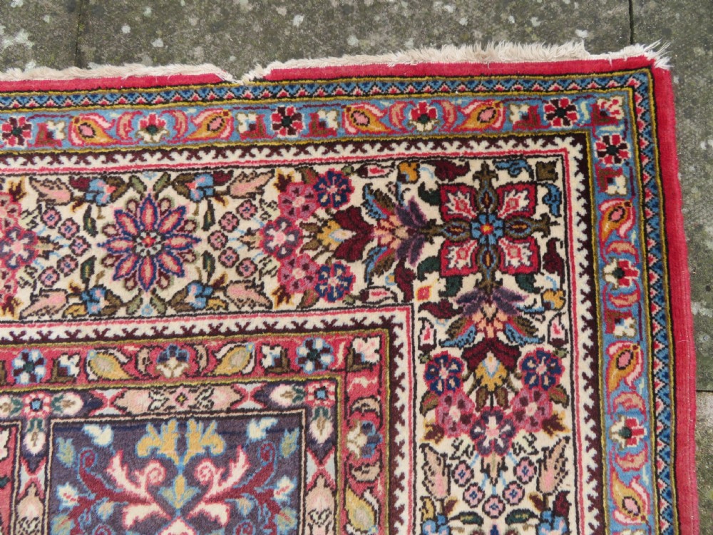 A large hand-knotted Persian Qum carpet with a square compartment panel design featuring floral and boteh motifs in red, blue, and cream enclosed by multi-band borders. View VIII