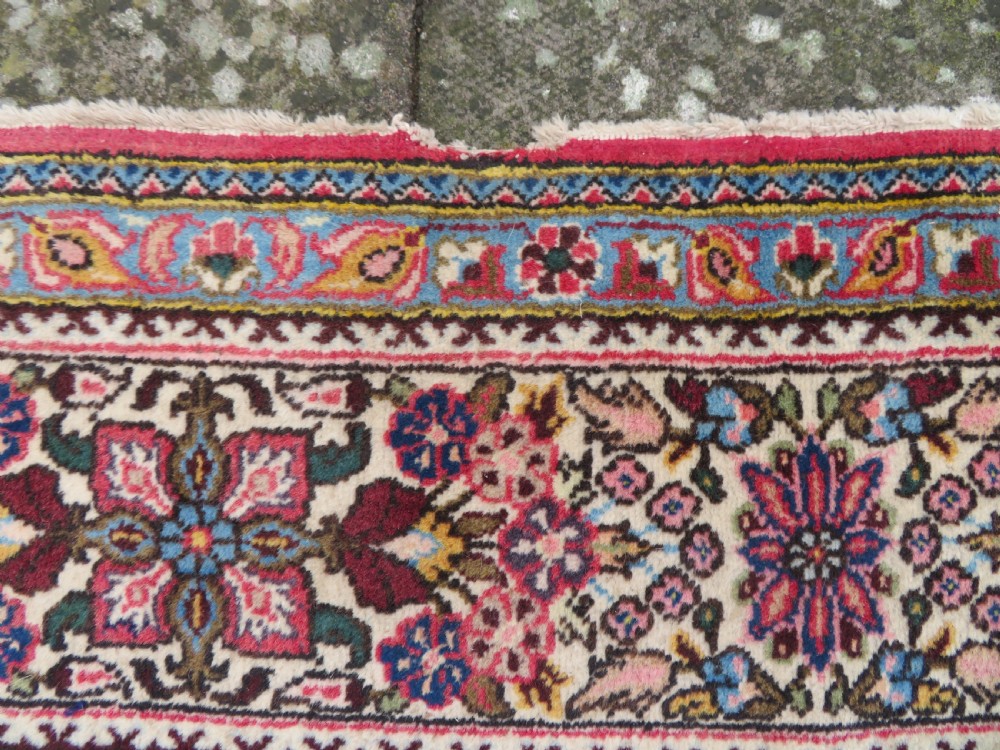A large hand-knotted Persian Qum carpet with a square compartment panel design featuring floral and boteh motifs in red, blue, and cream enclosed by multi-band borders. View IX