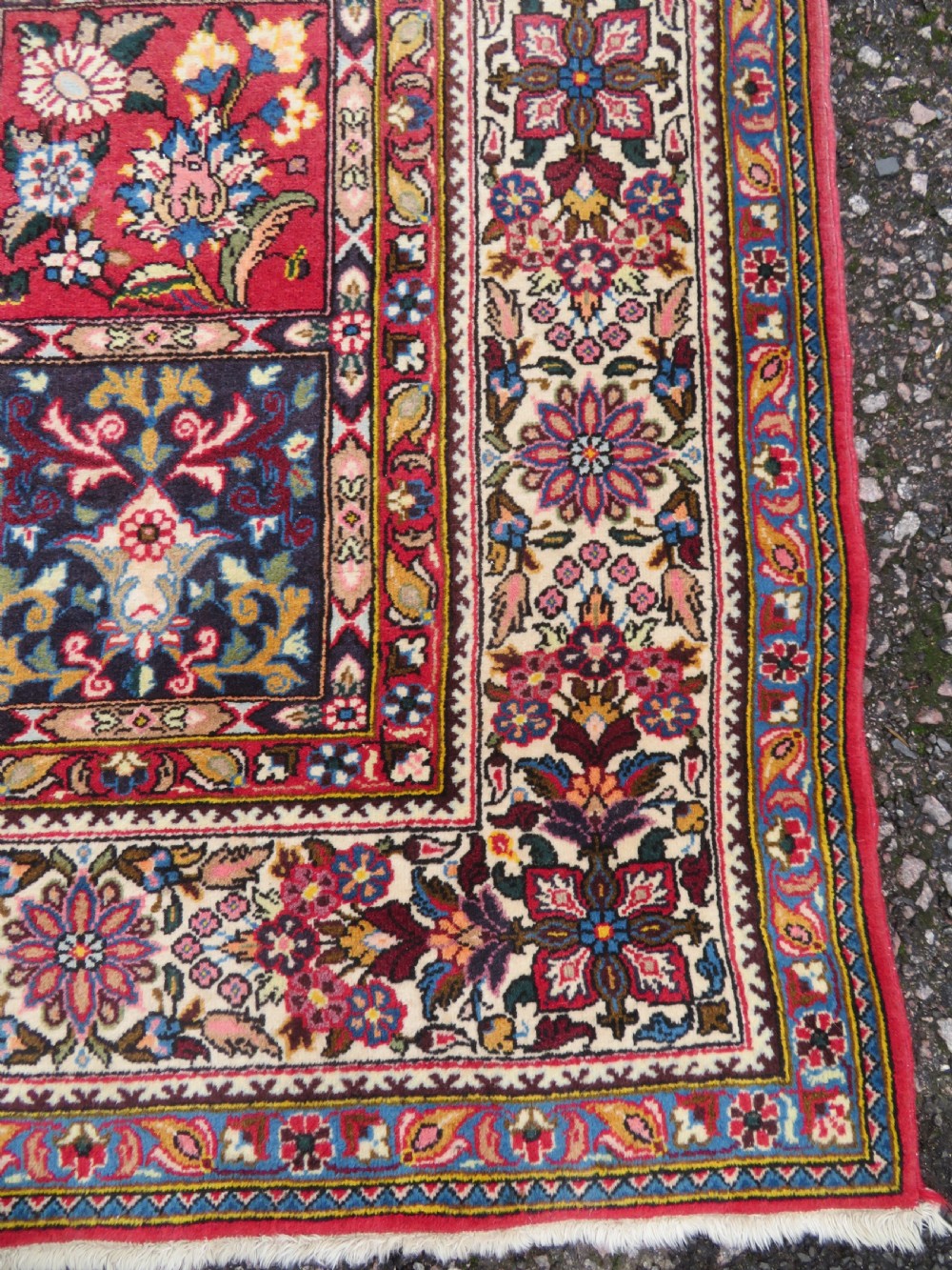 A large hand-knotted Persian Qum carpet with a square compartment panel design featuring floral and boteh motifs in red, blue, and cream enclosed by multi-band borders. View X