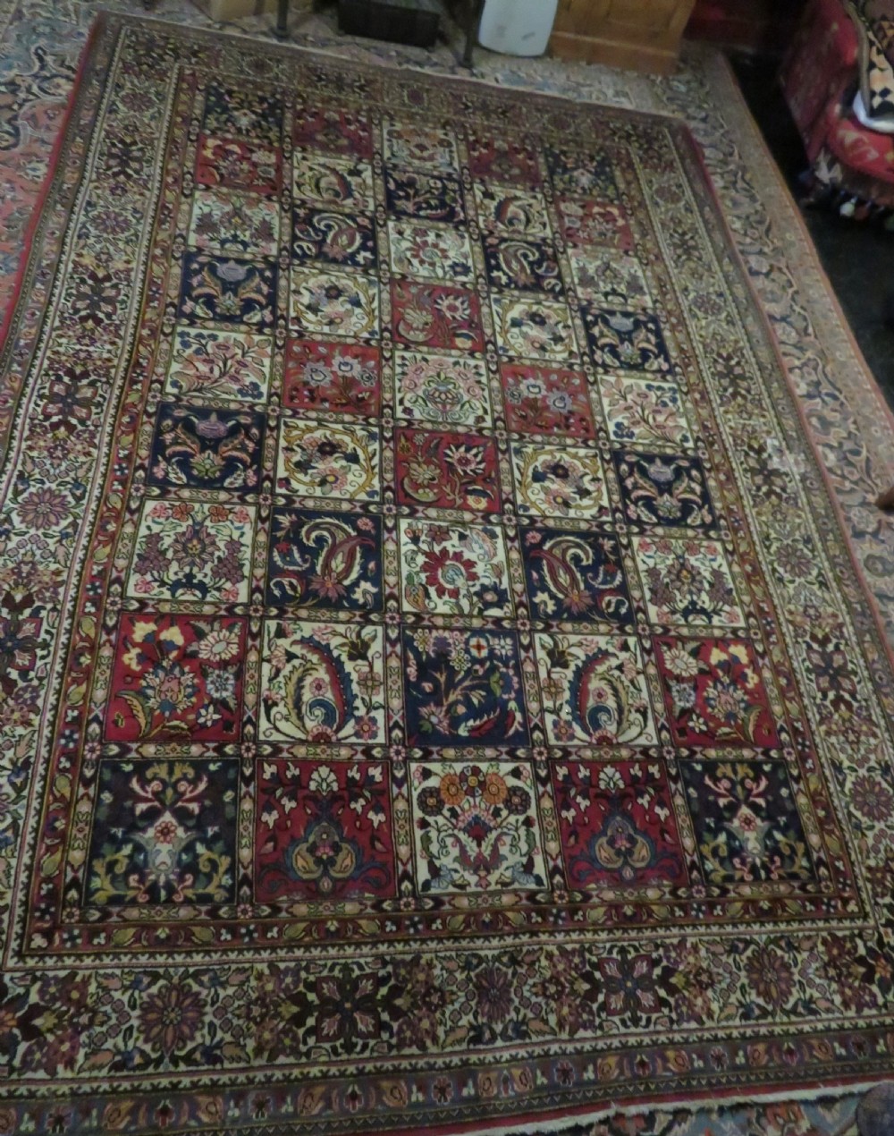 A large hand-knotted Persian Qum carpet with a square compartment panel design featuring floral and boteh motifs in red, blue, and cream enclosed by multi-band borders. View XVII