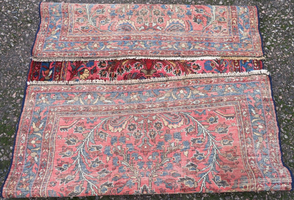An antique Persian Sarouk hand-knotted wool rug featuring a central floral medallion surrounded by intricate floral vine patterns in rose pink, light blue, navy, and ivory hues. View XVIII