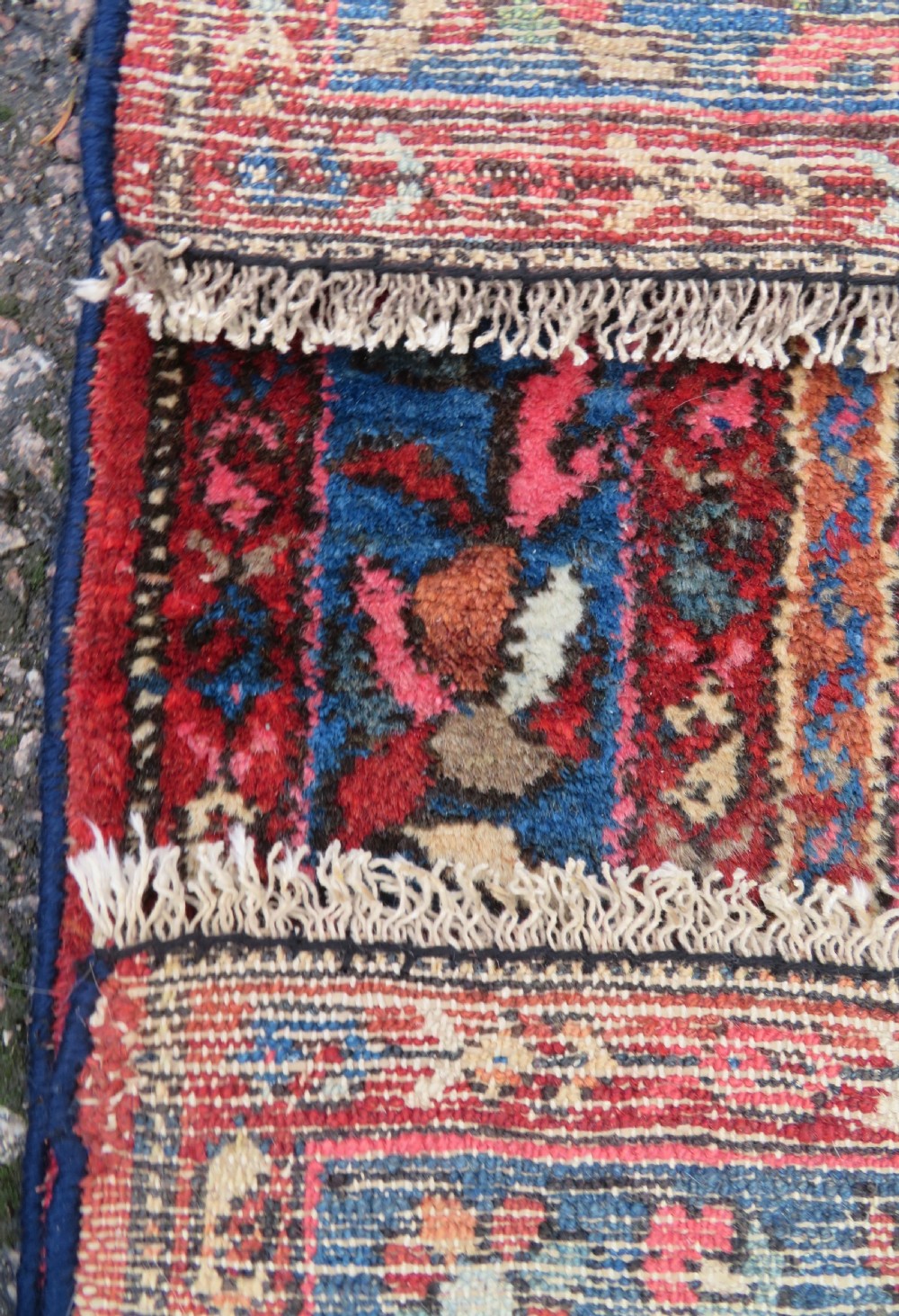 An antique Persian Sarouk hand-knotted wool rug featuring a central floral medallion surrounded by intricate floral vine patterns in rose pink, light blue, navy, and ivory hues. View XIX