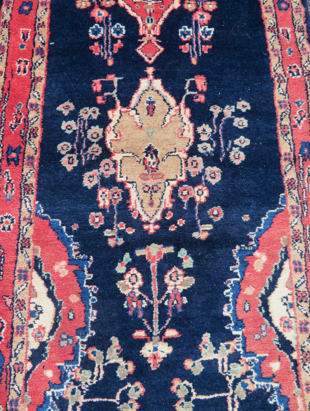 An extra-long antique Persian Sarouk runner rug crafted in wool with navy blue, crimson red, and ivory floral medallion motifs. View VI