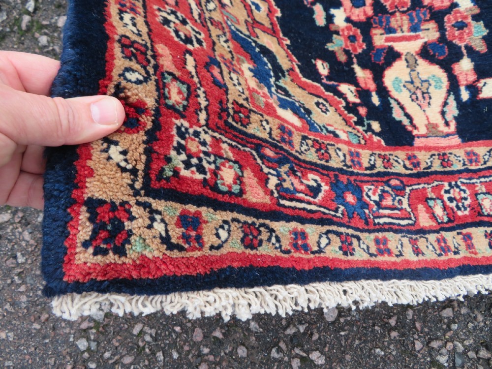 An extra-long antique Persian Sarouk runner rug crafted in wool with navy blue, crimson red, and ivory floral medallion motifs. View IX