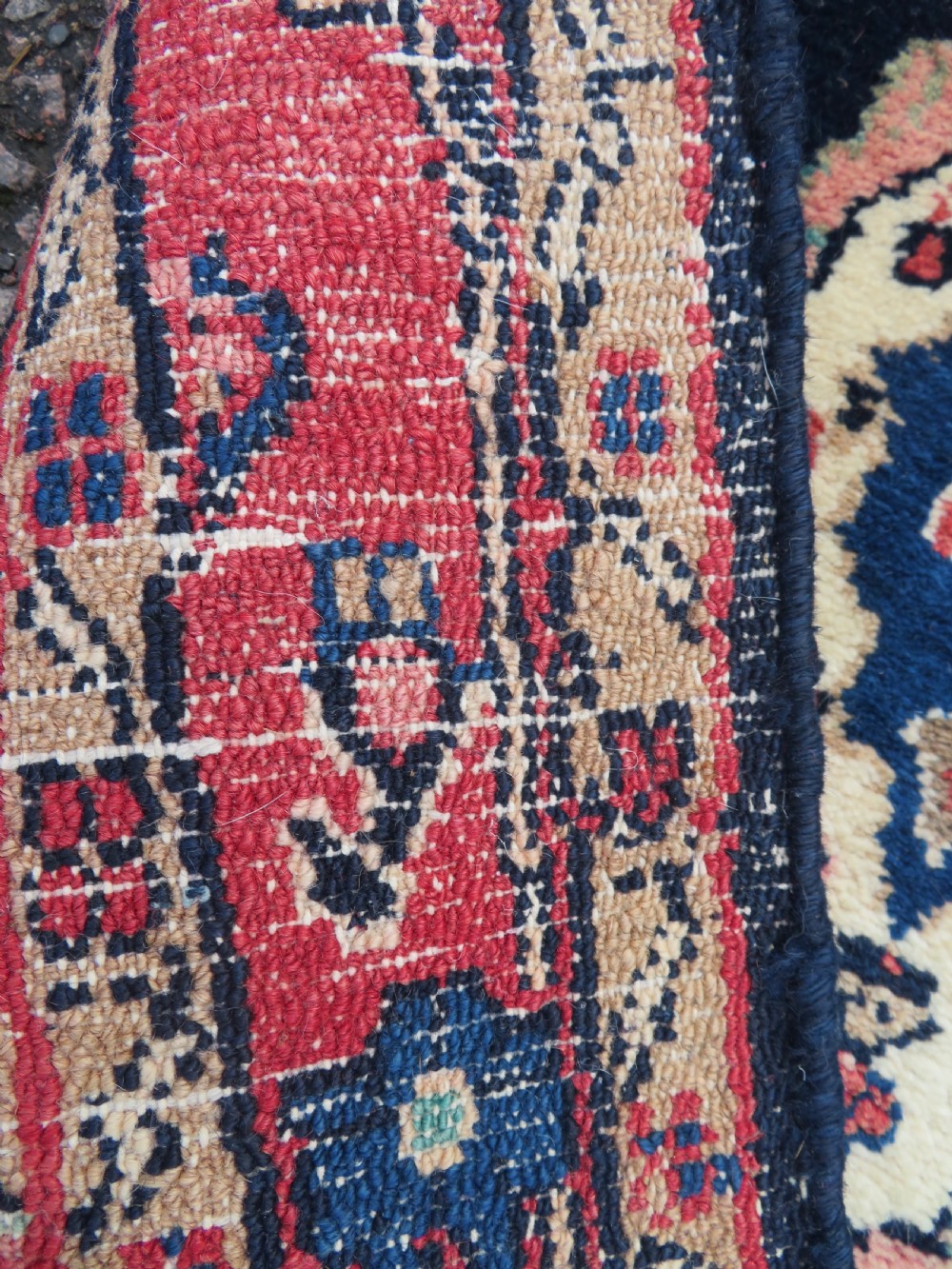 An extra-long antique Persian Sarouk runner rug crafted in wool with navy blue, crimson red, and ivory floral medallion motifs. View XII