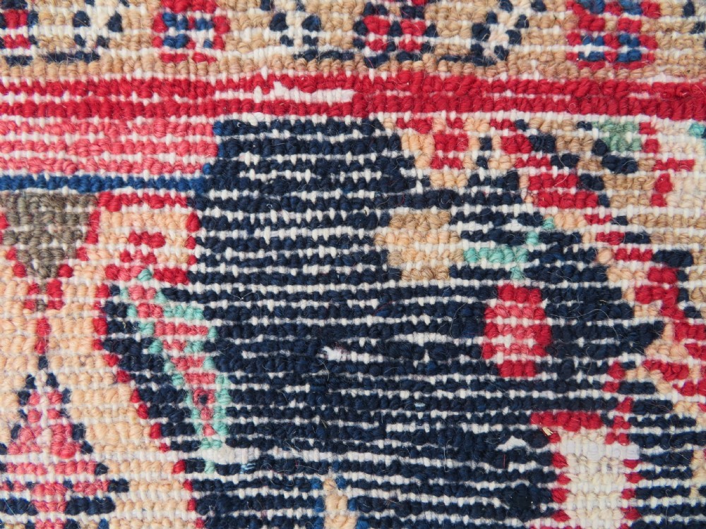 An extra-long antique Persian Sarouk runner rug crafted in wool with navy blue, crimson red, and ivory floral medallion motifs. View XIX