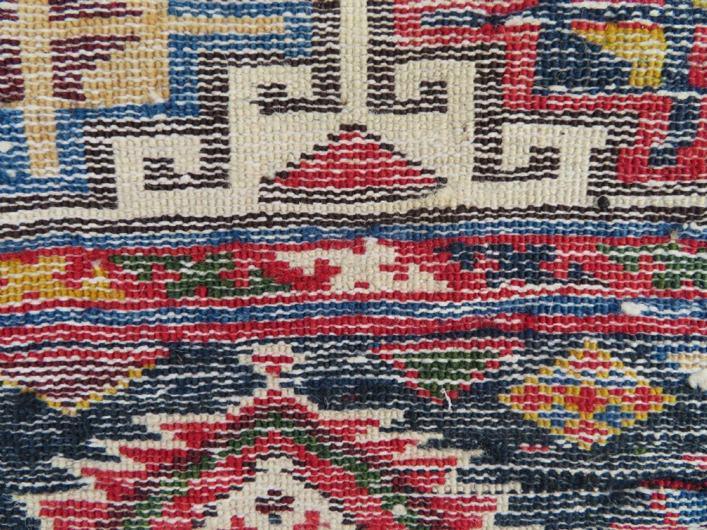 An antique Caucasian Kazak wool runner rug with repeating boteh motifs on a navy blue field framed by geometric multicoloured borders. View XVIII
